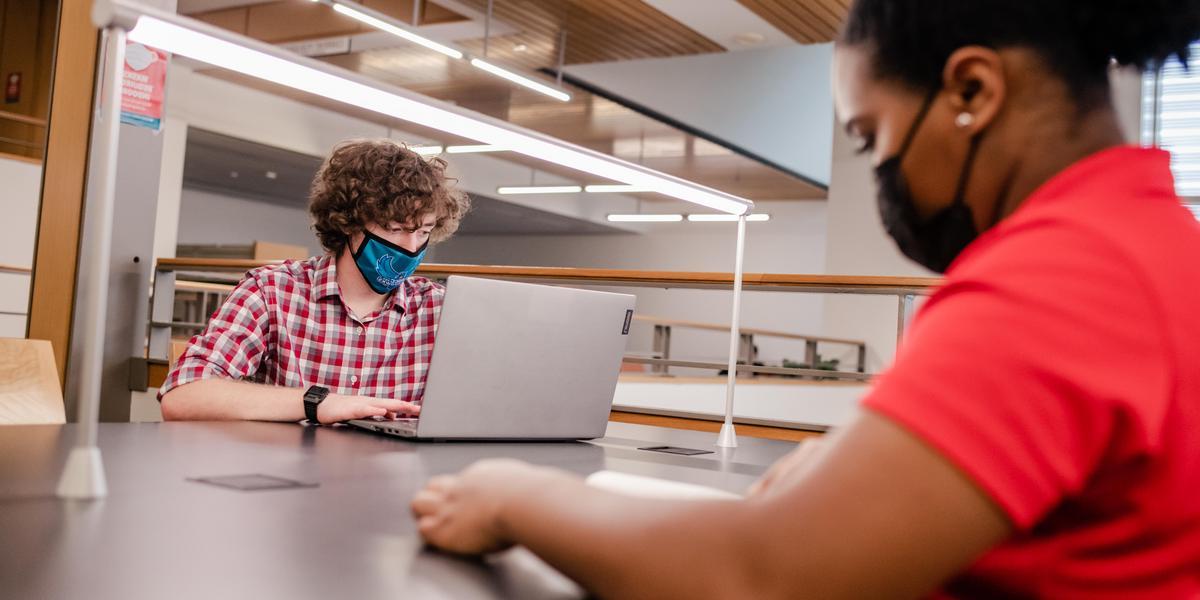 Students studying inside the AACC library.